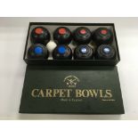 A boxed set of miniature carpet bowls.