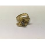 A continental contemporary gold ring inset with tw