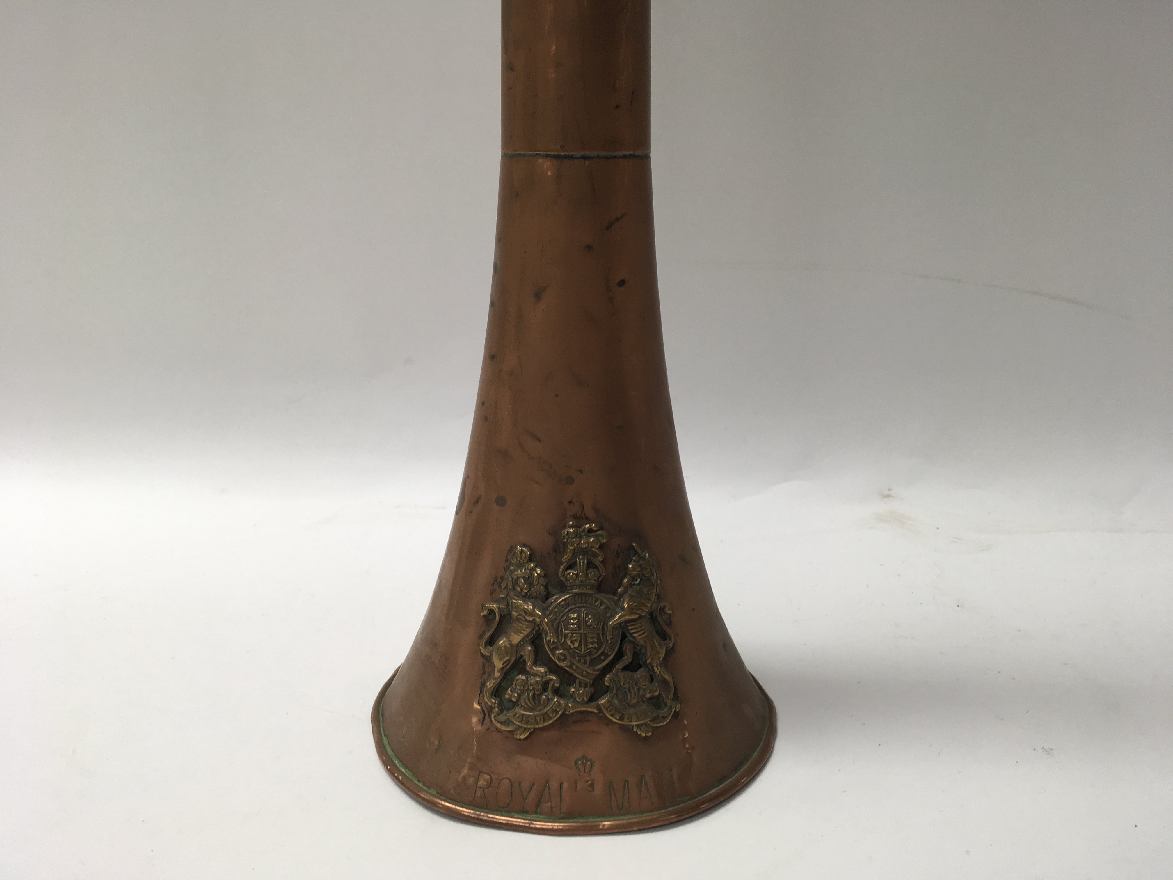 A large copper horn with “Royal Mail” stamped and attached brass coat of arms. Length approx 117cm.