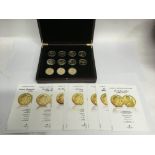 A wooden cased Royal Crown set, comprising eleven gold plated coins with certificates, lacking one