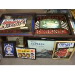 Seven framed vintage advertising signs and mirrors.