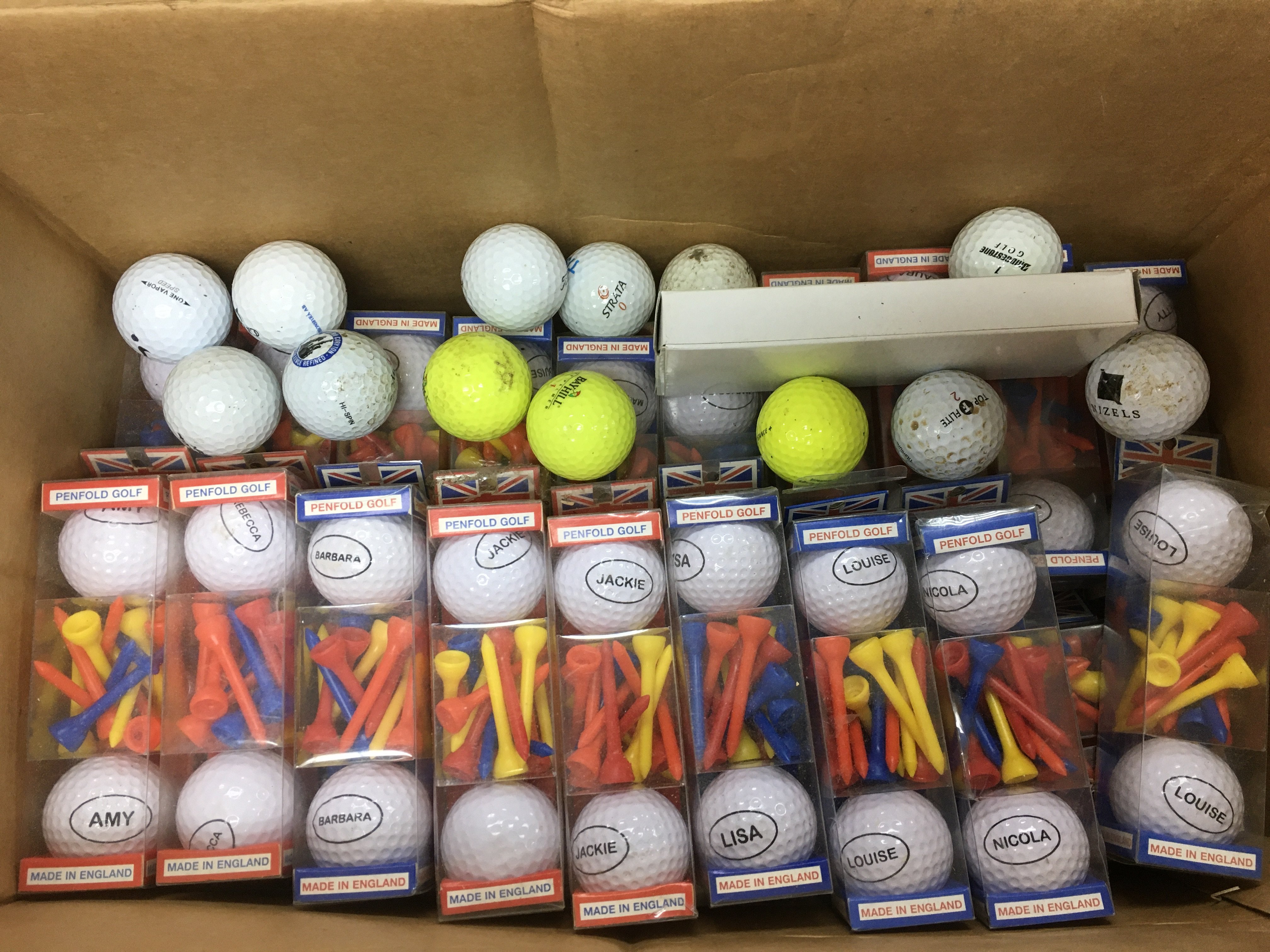 A box of golf balls and tees.