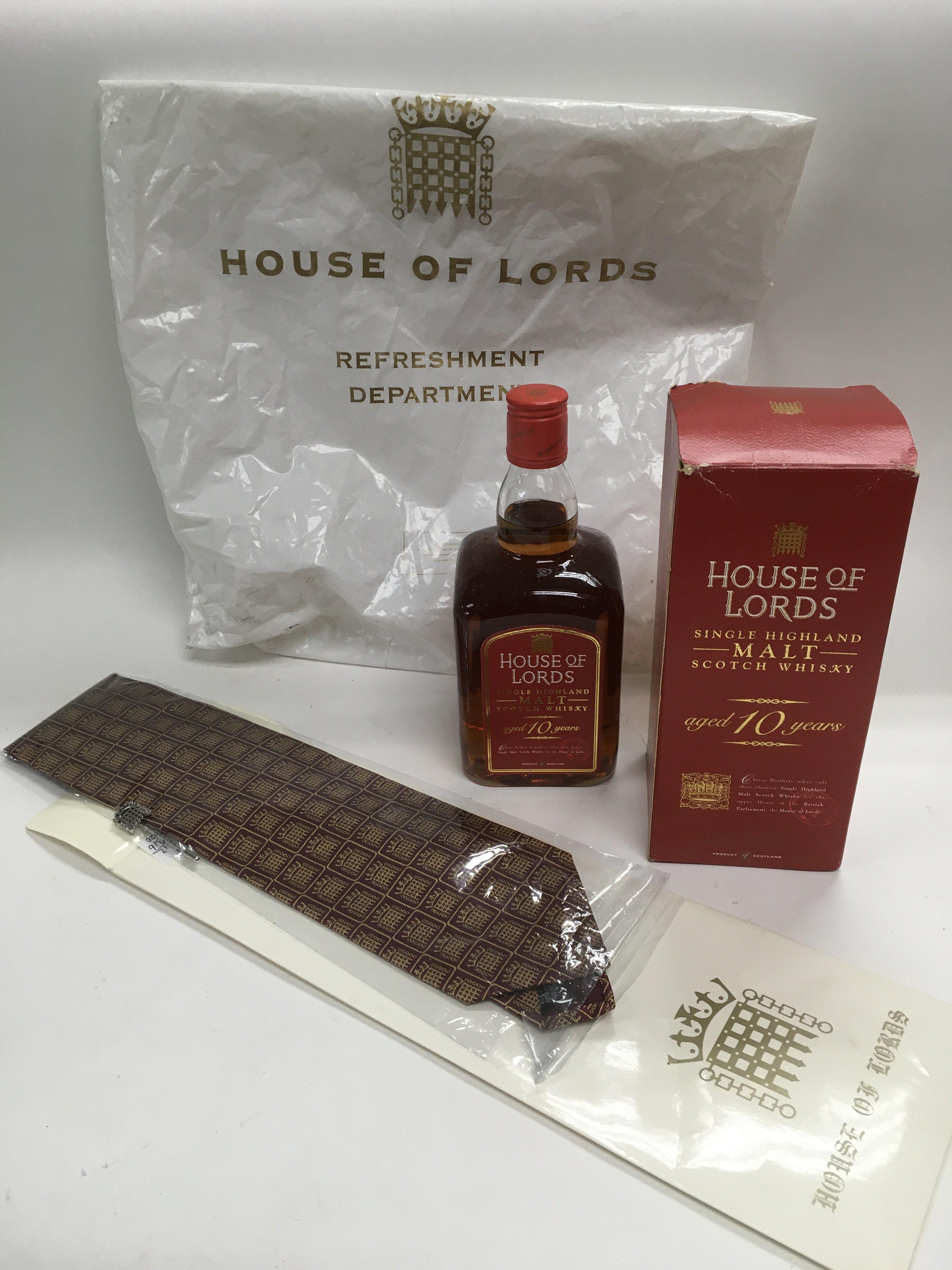 A boxed 70cl bottle of House Of Lords single malt whisky, associated tie, tie pin and carrier bag.