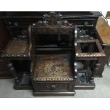 A carved oak hall seat with lift top seat and side stands.Approx 110x117cm high