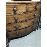 A Victorian mahogany bow fronted chest of drawers fitted with two short and three long drawers