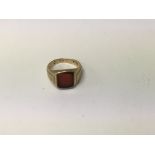 A gold signet ring marks worn size L