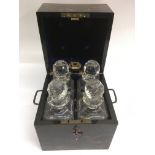 A coromandel decanter box with fitted interior containing four cut glass bottles.Approx 21x21x25cm