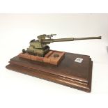A II World war model of a large gun emplacement on a mahogany base.
