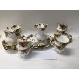 A small collection of royal Albert country rose including cups saucers and side plates .