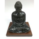 A 20th century bronze Buddha on wooden stand. Model approx 23x30cm