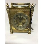 A dual brass cased barometer / mantel clock inset with compass the silver chapter ring with Arabic