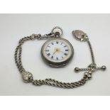 A silver button wind pocket watch with watch chain.