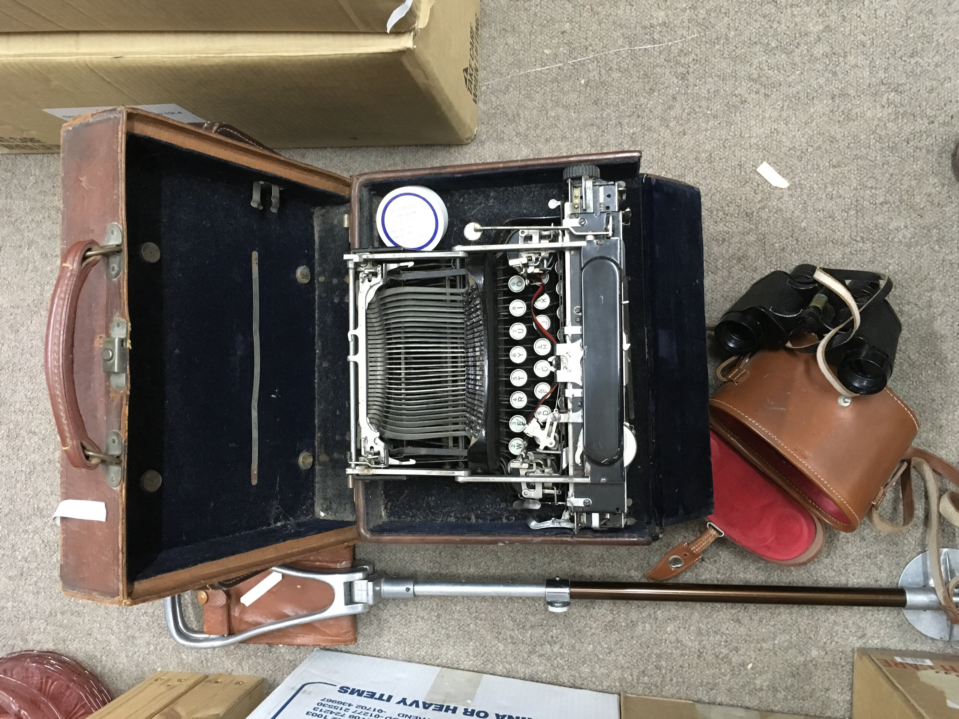 A cased type writer, leather case, pair of binoculars and shooting stick