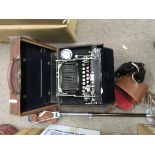 A cased type writer, leather case, pair of binoculars and shooting stick