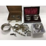 A collection of mainly silver items including a cigarette box, bangle, napkin rings and jewellery.