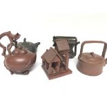 A collection of five Chinese terracotta late Republic tea pots in the form of a basket and a