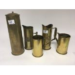 A collection I World War Trench Art brass jugs made from shell case and with inscriptions such as