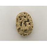 A late 19th Century Carved ivory Chinese brooch. 4cm.