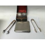 A silver cigarette case and a small collection of
