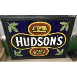 An enamel Hudson's soap advertising sign, framed .Approx 76x101cm, some restoration