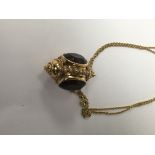 A Victorian style pendant/ fob inset with amethyst stones with attached chain.