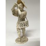 A 19th century Japanese ivory figure carrying eggs within a basket 32 cm inset with signed red