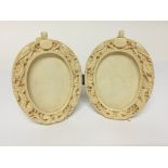 A late 19th Century Carved ivory double oval picture frame Hight 11cm