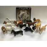 A collection of Beswick dogs and a boxed plate.