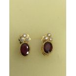A pair of 18ct gold ruby and diamond set earrings