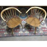 A pair of Ercol light wood , curved back chairs.Some wear