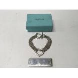 A Tiffany & Co money clip and bracelet in a box.