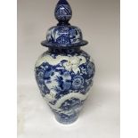 A large Chinese blue and white floor vase With lid decorated with a raised dragon birds flowers