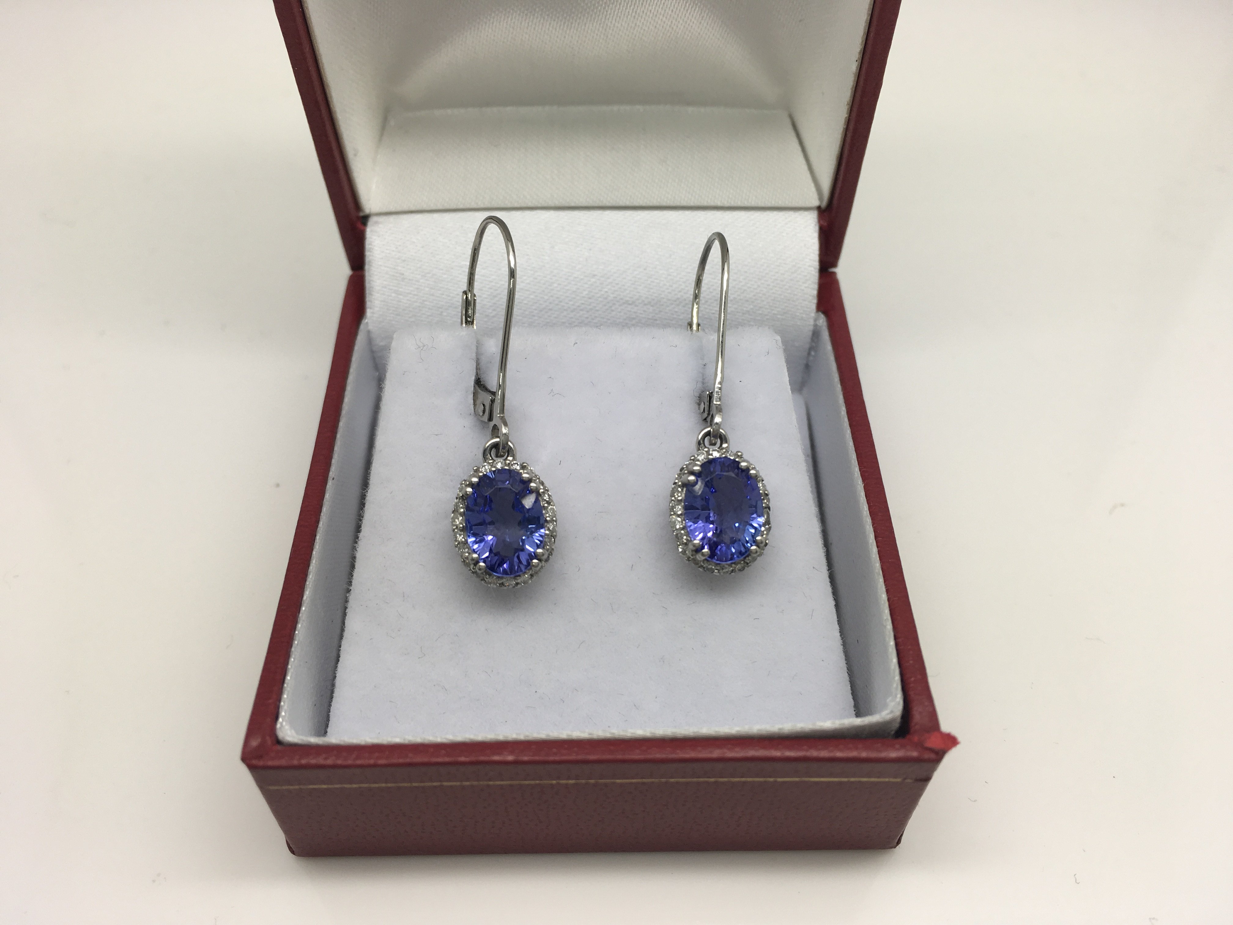 A pair of platinum earrings set with diamonds and