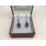 A pair of platinum earrings set with diamonds and
