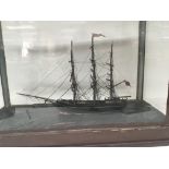 A late 19th or early 20th Century scratch built model boat in a glass case the British ship named
