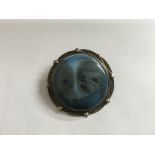 An Arts and Crafts, Liberty style brooch; white metal mounted with large blue ceramic roundel.Approx