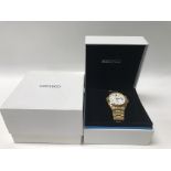 A boxed gentleman's gold tone Seiko wristwatch.