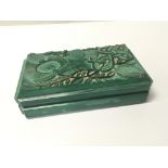 An Art Deco jade glass cigarette box the top with