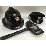 A collection of Fire service items comprising a vintage axe, helmet and hat.