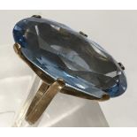 A 9ct gold ring, set with a large oval shape blue stone.Approx M