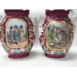 A pair of Victorian vases decorated with figures in garden views 33 cm