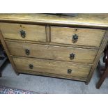 A oak chest of drawers fitted with two short and two long drawers