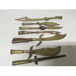 A collection of seven trench art I world War paper knifes one with a carved wood rifle but handle
