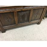 A oak blanket box with panelled front