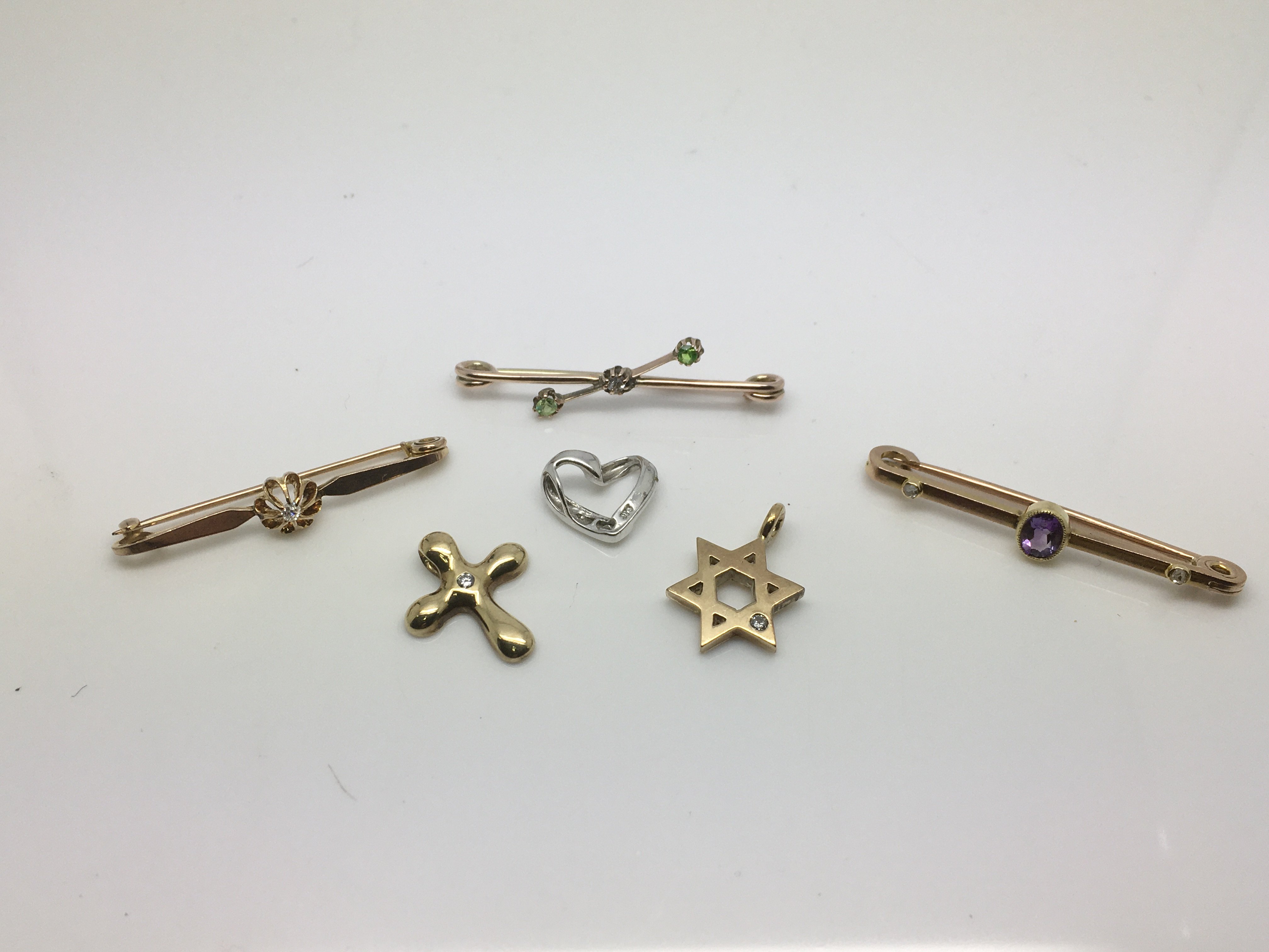 A group of six diamond set items comprising three stick brooches and three pendants, approx total