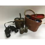 Four pairs of vintage binoculars.