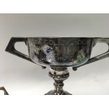 A pair of silver trophy cups, one standing approx