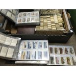 A collection of cigarette cards and tea cards, loose and in albums.