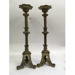 A pair of brass candle sticks with gothic influences 50 cm