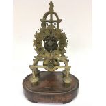 A brass skeleton clock having Roman Numeral dial on wooden base.Approx 34cm high.